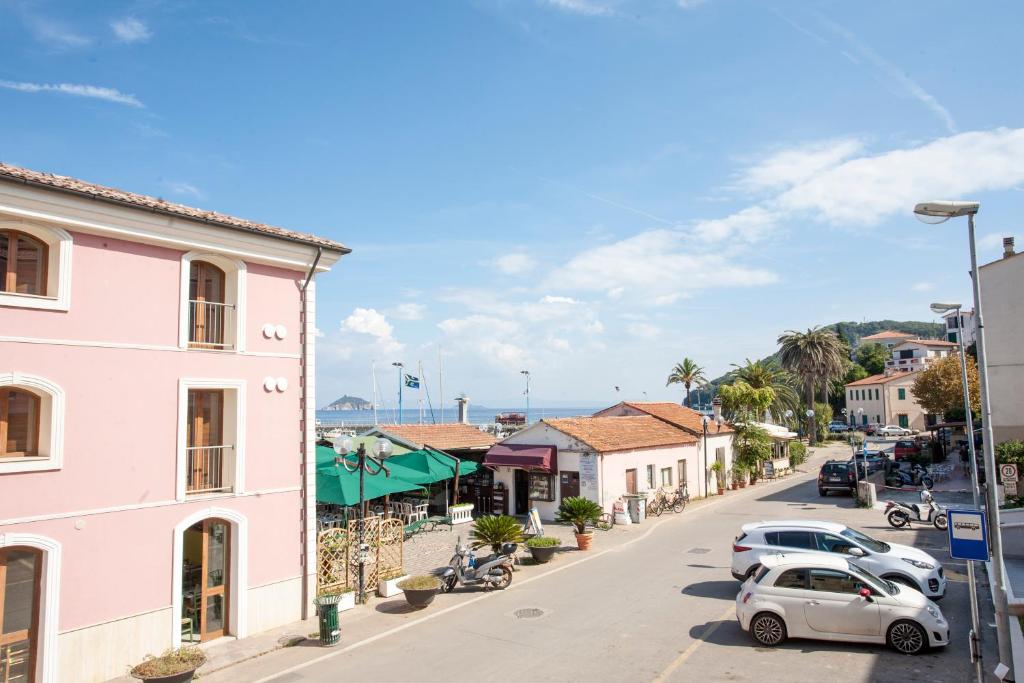 a street in a town with cars parked at Appartamenti Sole e Luna in Rio Marina