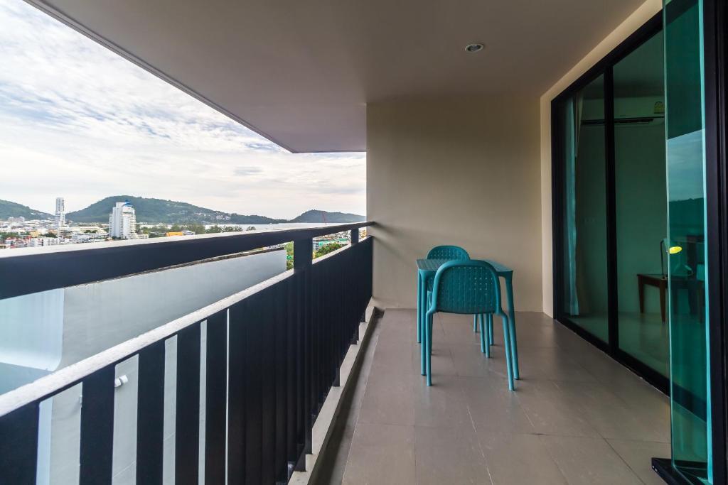 a balcony with a chair and a view of the water at Apartments at The Bliss Condo by Lofty in Patong Beach