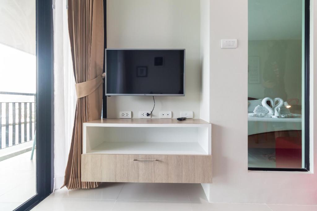 a tv sitting on top of a cabinet in a room at Apartments at The Bliss Condo by Lofty in Patong Beach