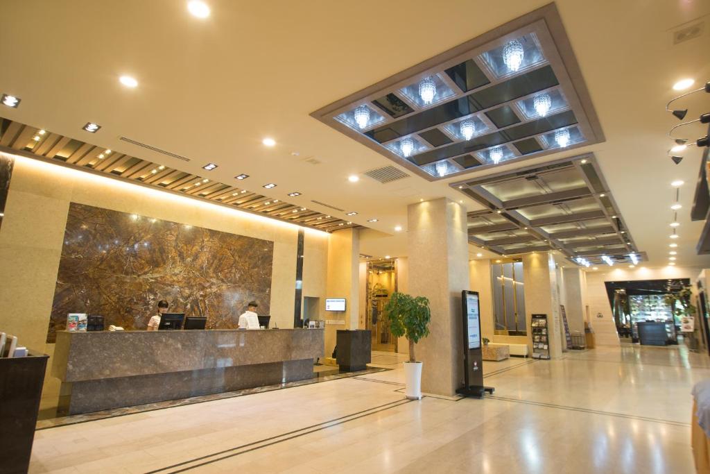 a lobby with a reception desk in a building at Hotel International Changwon in Changwon