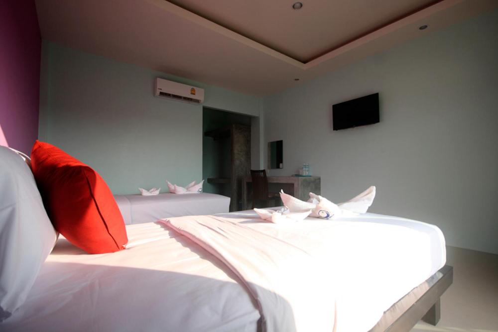 Postel nebo postele na pokoji v ubytování The Aireen Hotel