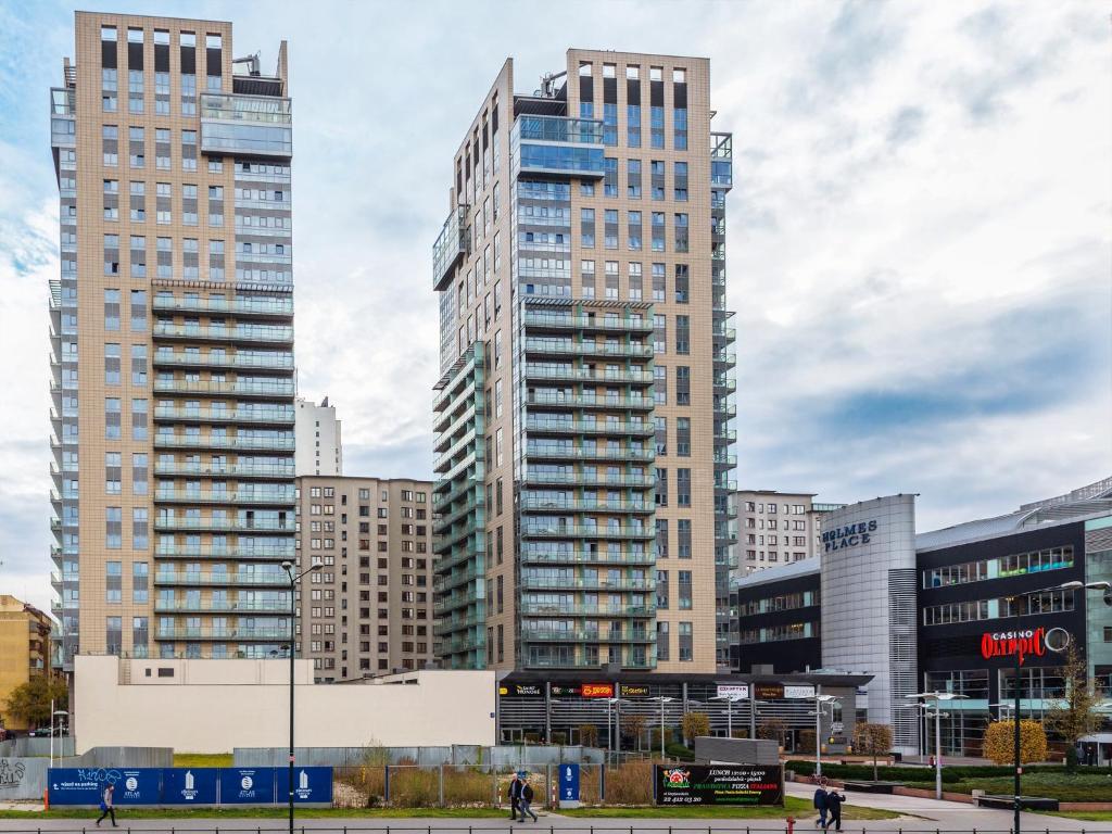 a group of tall buildings in a city at Chopin Apartments - Platinum Towers in Warsaw