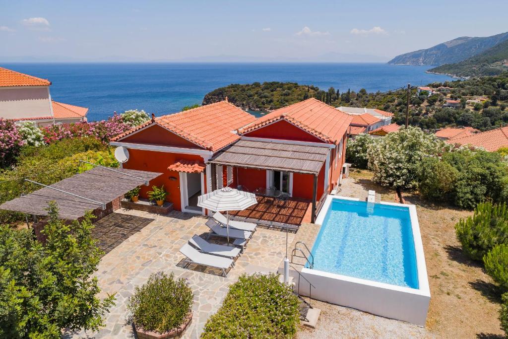 an aerial view of a house with a swimming pool at Mouzakis Villas in Agía Paraskeví