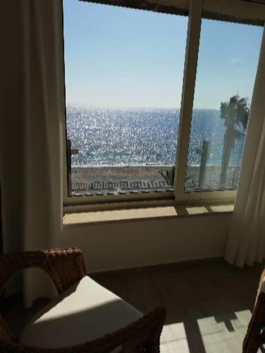 a room with a window with a view of the ocean at Akron B&B in SantʼAlessio Siculo