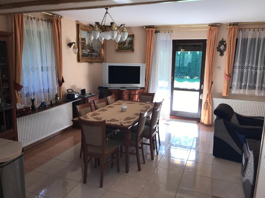 a dining room with a table and chairs and a television at Krościenko nad Dunajcem Jagielońska 179/1 in Krościenko
