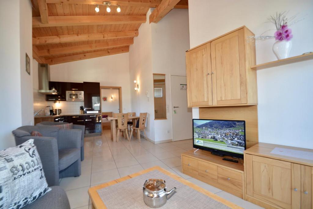 a living room with a tv and a kitchen at Apartment Peter in Adler Resort by Z-K-H Rentals in Kaprun