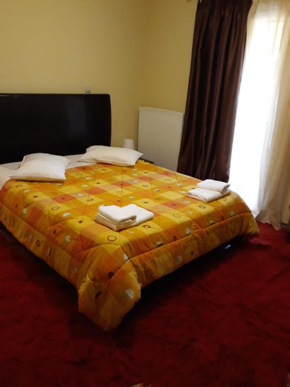 a large bed with towels on top of it at Ageri in Karpenision