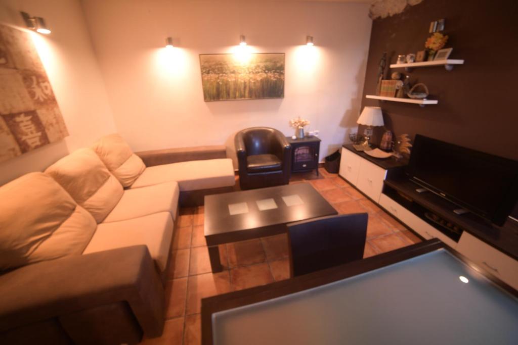 a living room with a couch and a table at Casa Rural La Roca in Alcalá del Júcar