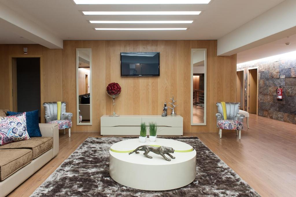 a living room with a couch and a tv at Mondim AL & Spa in Mondim de Basto