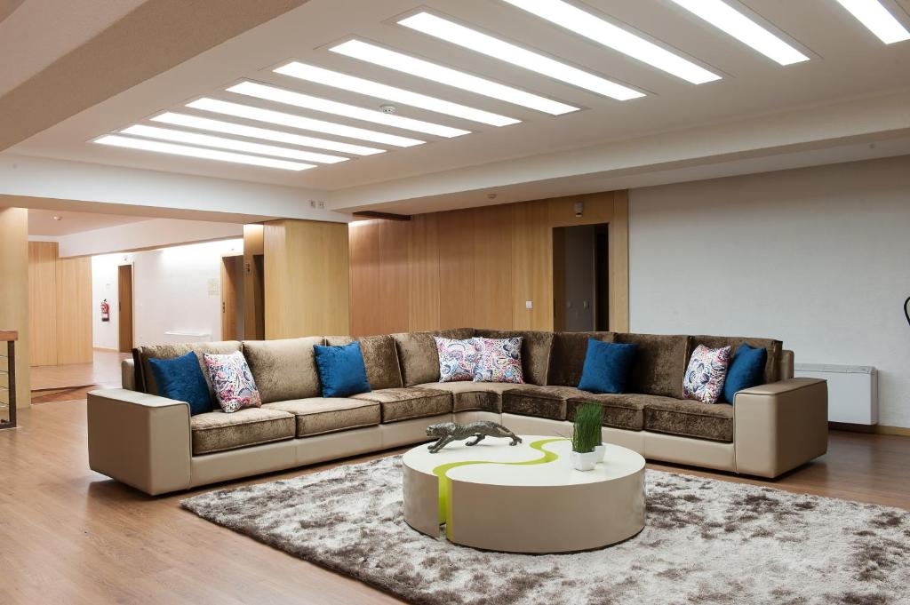 a living room with a couch and a table at Mondim AL & Spa in Mondim de Basto