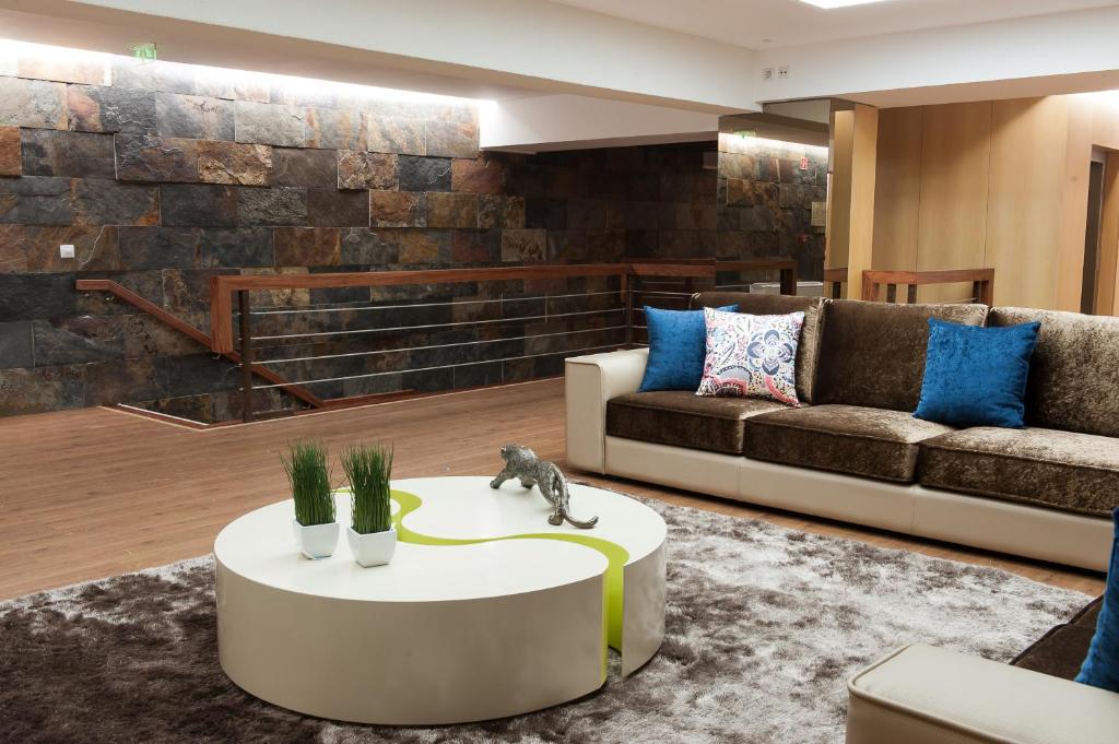 a living room with a couch and a table at Mondim AL & Spa in Mondim de Basto