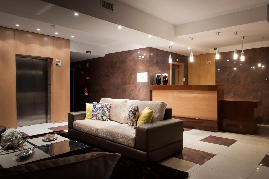 a living room with a couch and a table at Mondim AL & Spa in Mondim de Basto