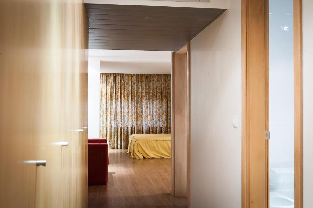 a view of a bedroom with a bed in the background at Mondim AL & Spa in Mondim de Basto