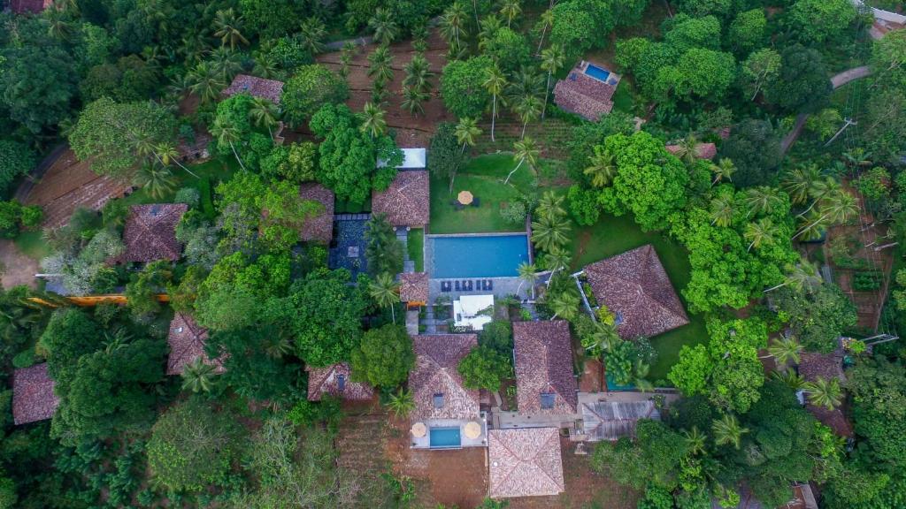 an overhead view of a yard with houses and trees at Kahanda Kanda in Koggala