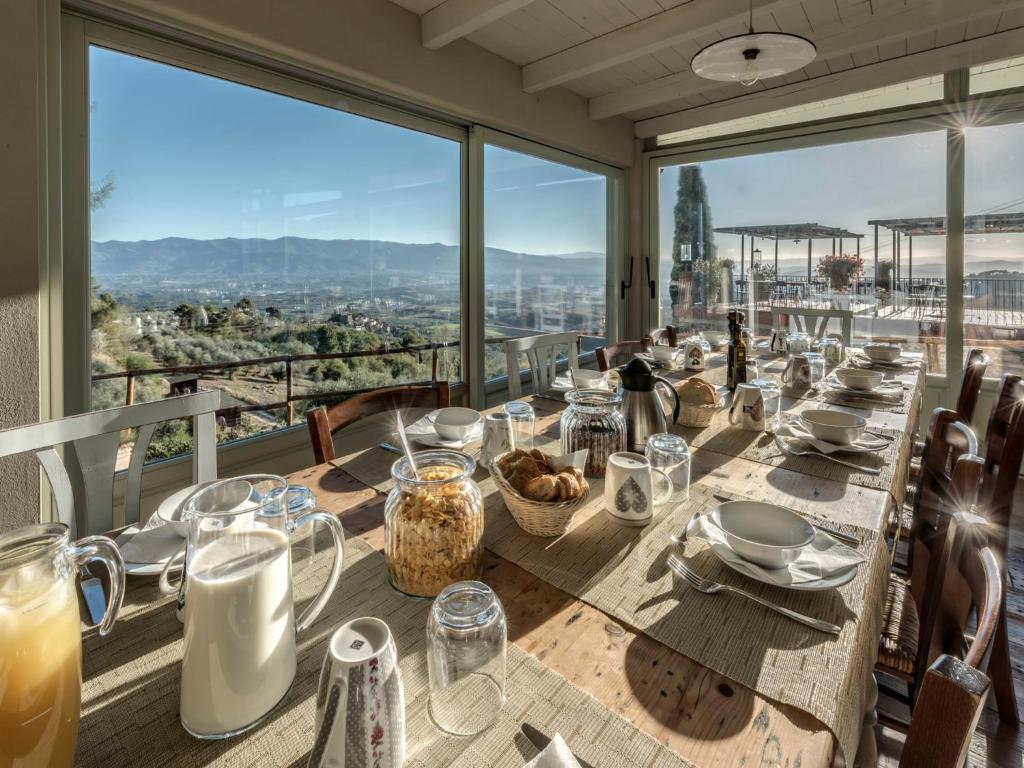 a long table with a view of the city at Agriturismo La Forra in Cavriglia