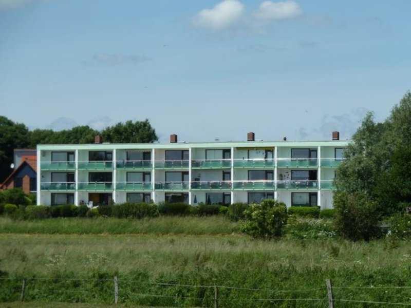 a large white building with windows in a field at Werder Anke in Rettin