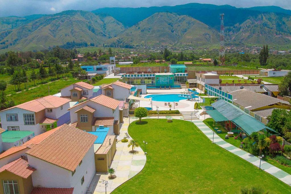 an aerial view of a resort with a pool and mountains at Hotel Regina Resort & Convenciones in Cochabamba