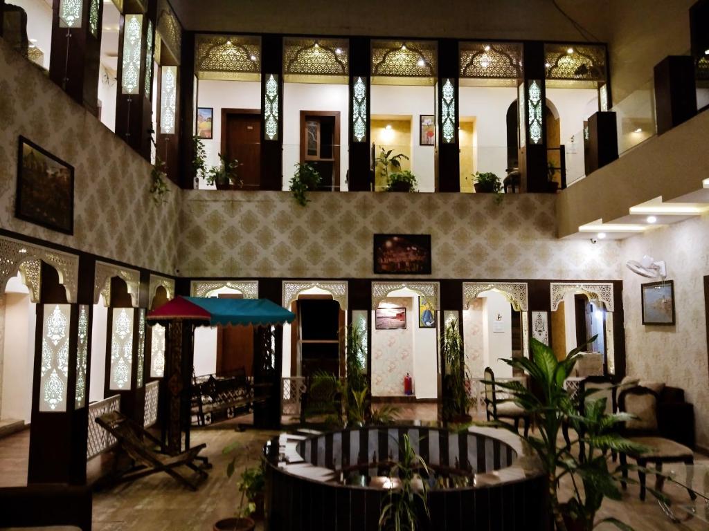 a lobby of a building with a large room at Dwivedi Hotels Sri Omkar Palace in Varanasi