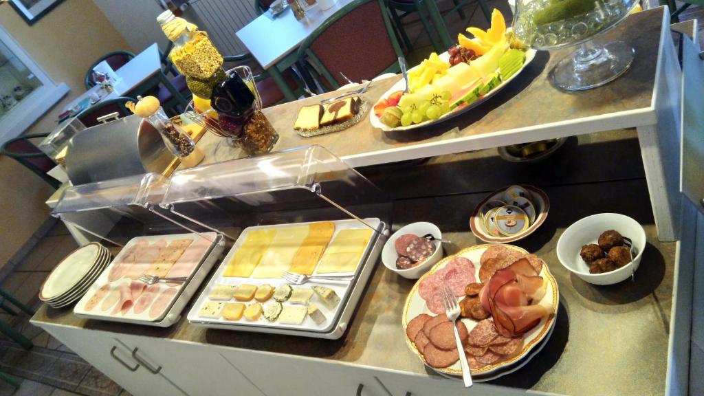 a buffet with many different types of food on a counter at Haus am Kurpark Hotel Garni in Bad Steben