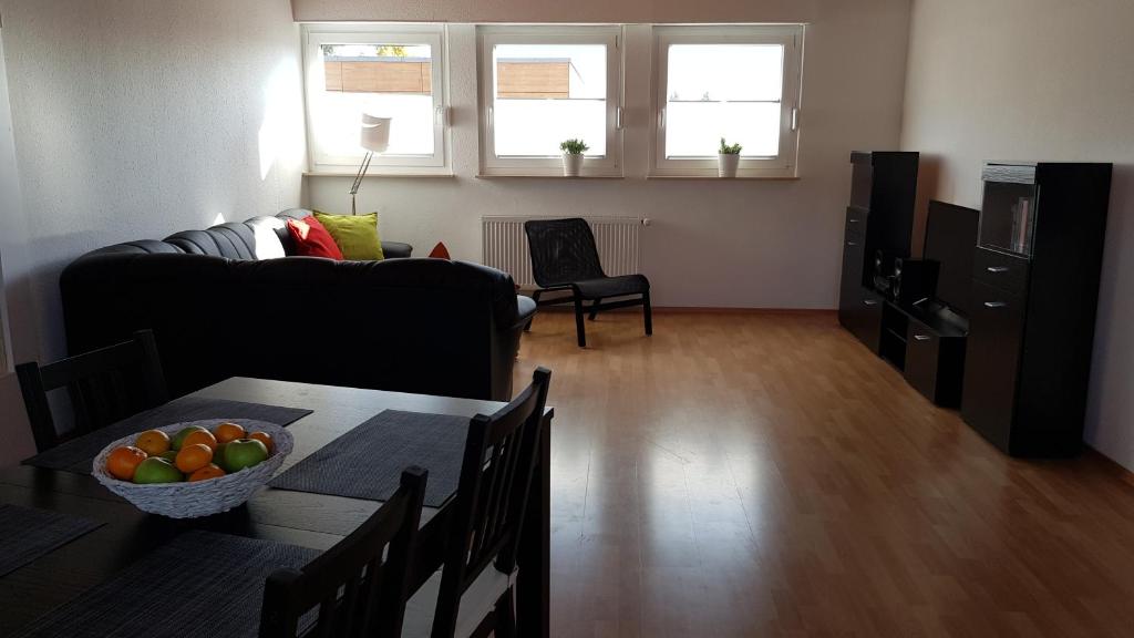 un soggiorno con divano e tavolo con cesto di frutta di Ferienwohnung Horvath in Kelkheim (Taunus) a Kelkheim