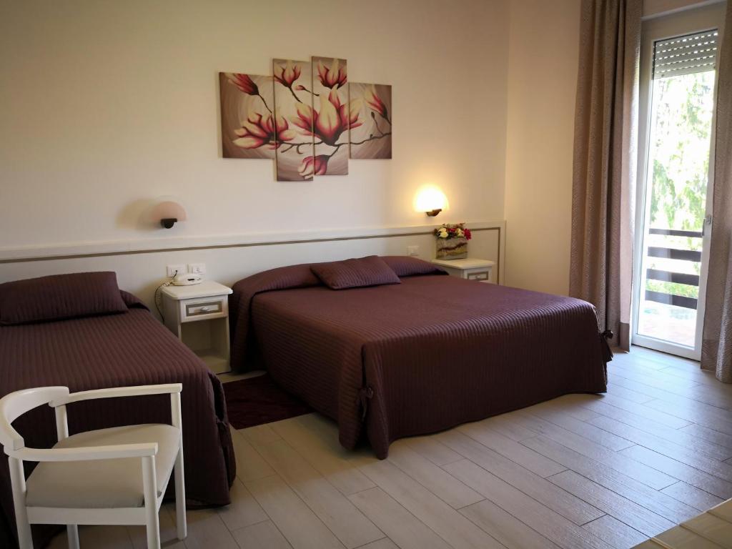 Postel nebo postele na pokoji v ubytování Albergo Ester