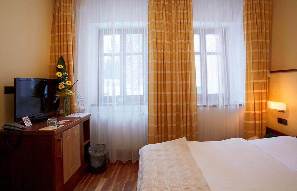 Postel nebo postele na pokoji v ubytování Hotel Penzion Na Hradě