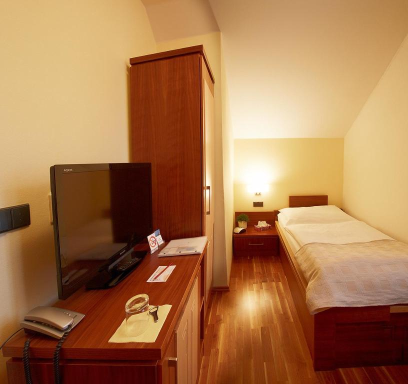Postel nebo postele na pokoji v ubytování Hotel Penzion Na Hradě