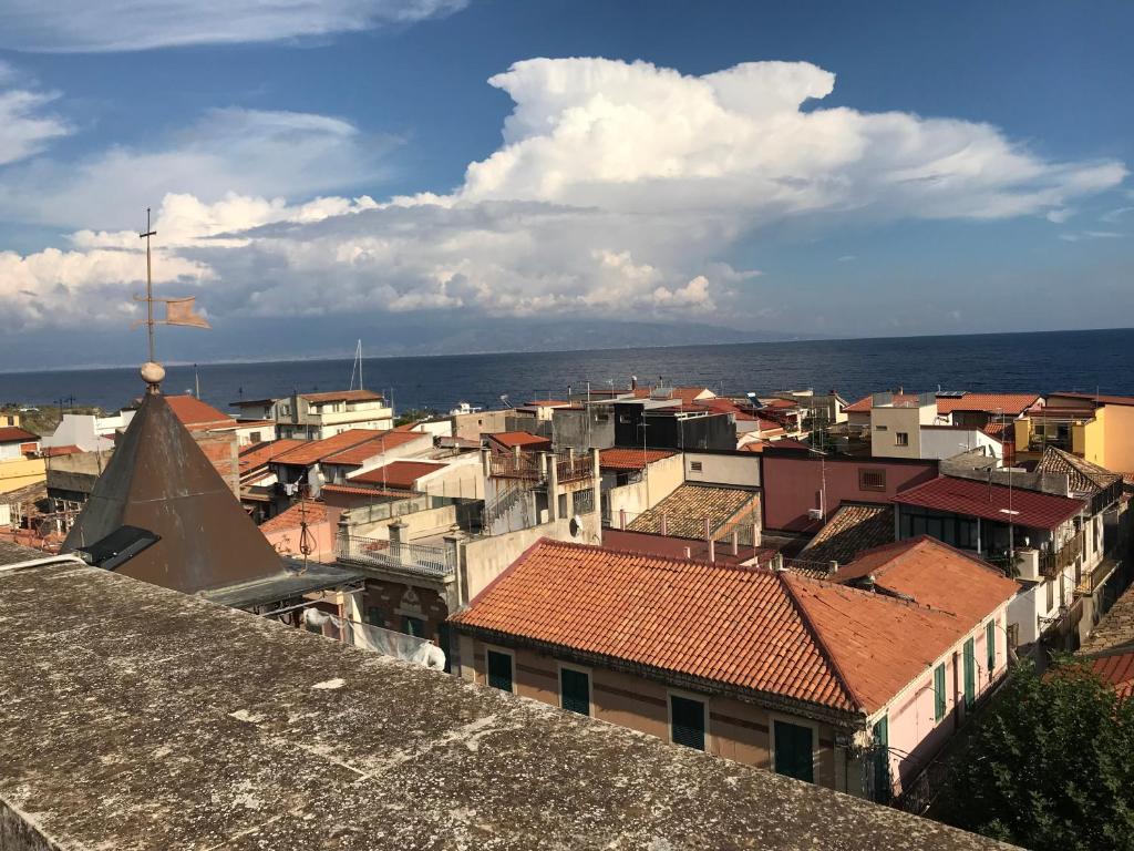 a view of a city with roofs and buildings at Castello D'Alcontres Guest House 3 stelle in Nizza di Sicilia