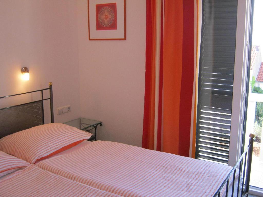 Postel nebo postele na pokoji v ubytování Apartments & Rooms Luna