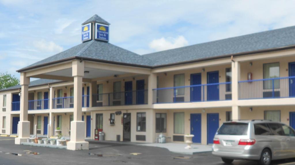 a building with a car parked in front of it at Executive Inn & Suites - Covington in Covington