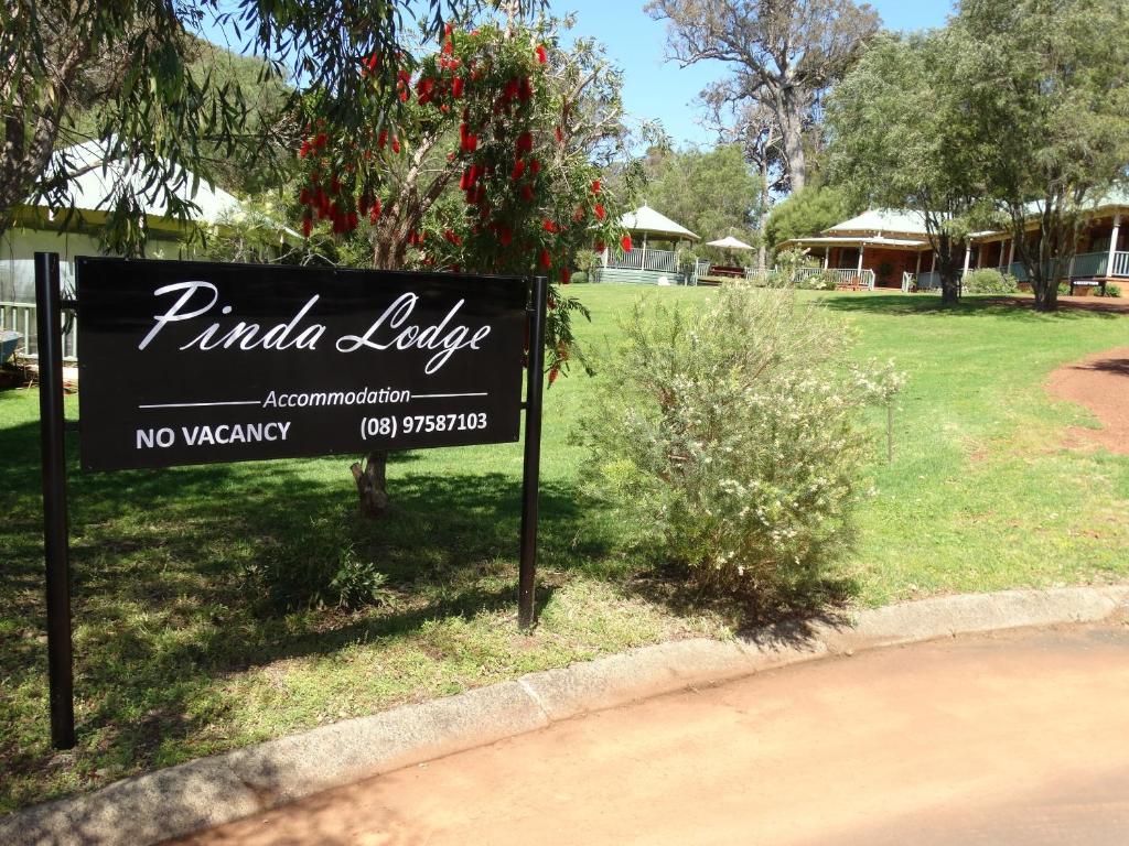 a sign for a public library in a park at Pinda Lodge in Margaret River Town