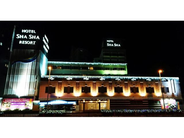 a building with a sign on it at night at Hotel ShaSha Resort Suma in Kobe
