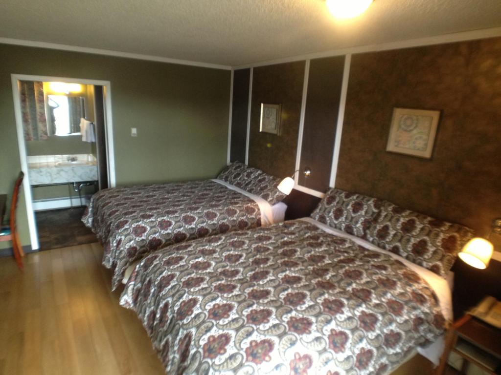 Postel nebo postele na pokoji v ubytování Galaxy Motel