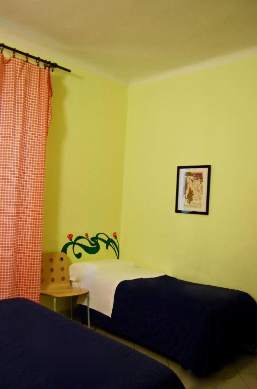Postel nebo postele na pokoji v ubytování AlbergoTeatro