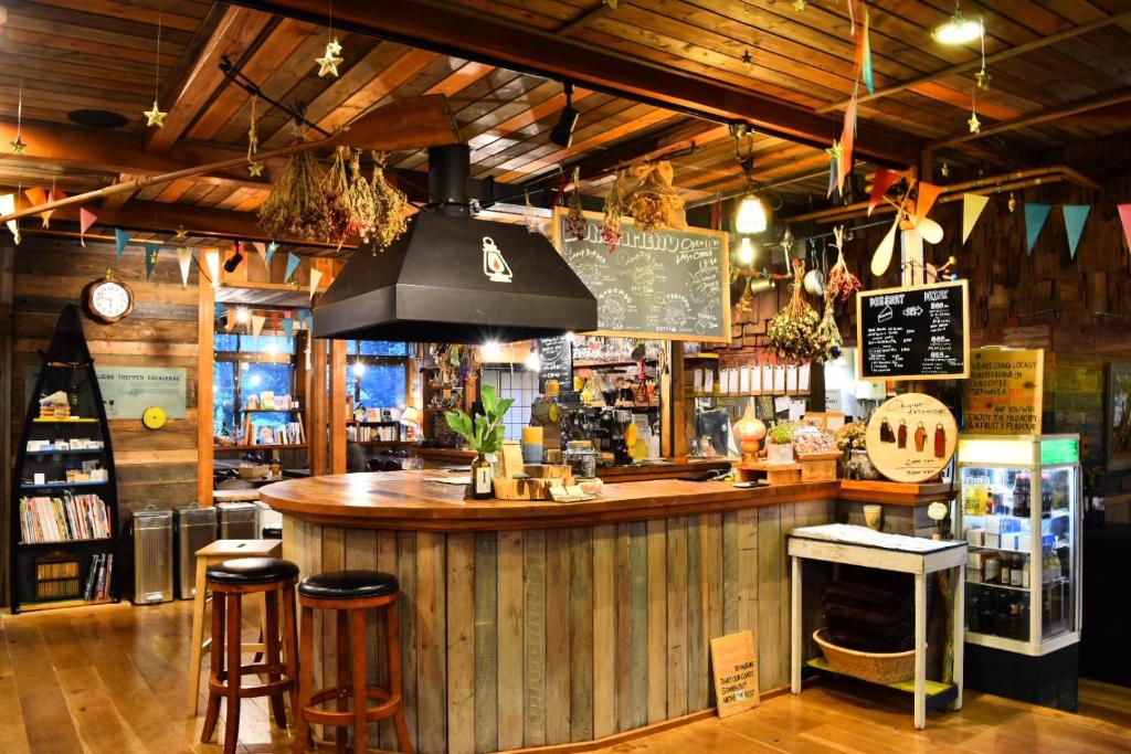 a bar in a restaurant with a counter and stools at LAMP Nojiriko in Shinano