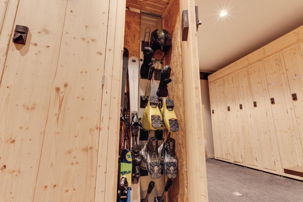 a bunch of skis are hanging in a room at Hôtel Avancher in Val-d'Isère