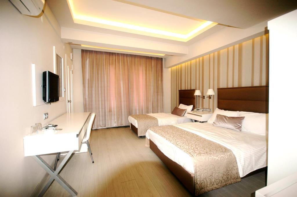 Ένα ή περισσότερα κρεβάτια σε δωμάτιο στο Kent Hotel