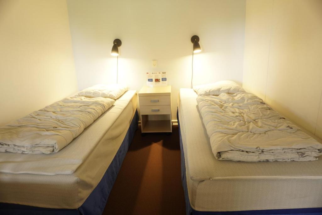 Rúm í herbergi á Danhostel Ishøj Strand