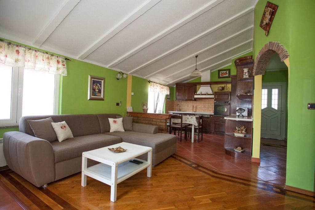 a living room with a couch and a table at Apartments Tin in Rovinj