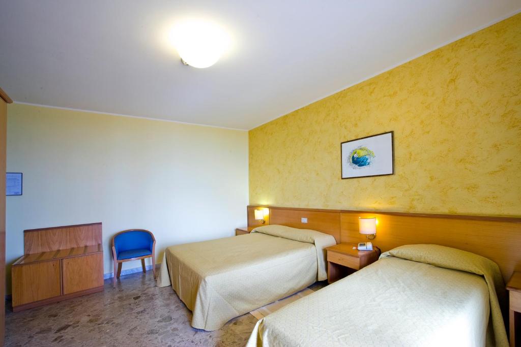 Postel nebo postele na pokoji v ubytování Hotel La Tonnara