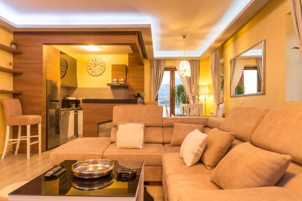 a living room with a couch and a table at Blanche Cliff Apartments in Sveti Stefan