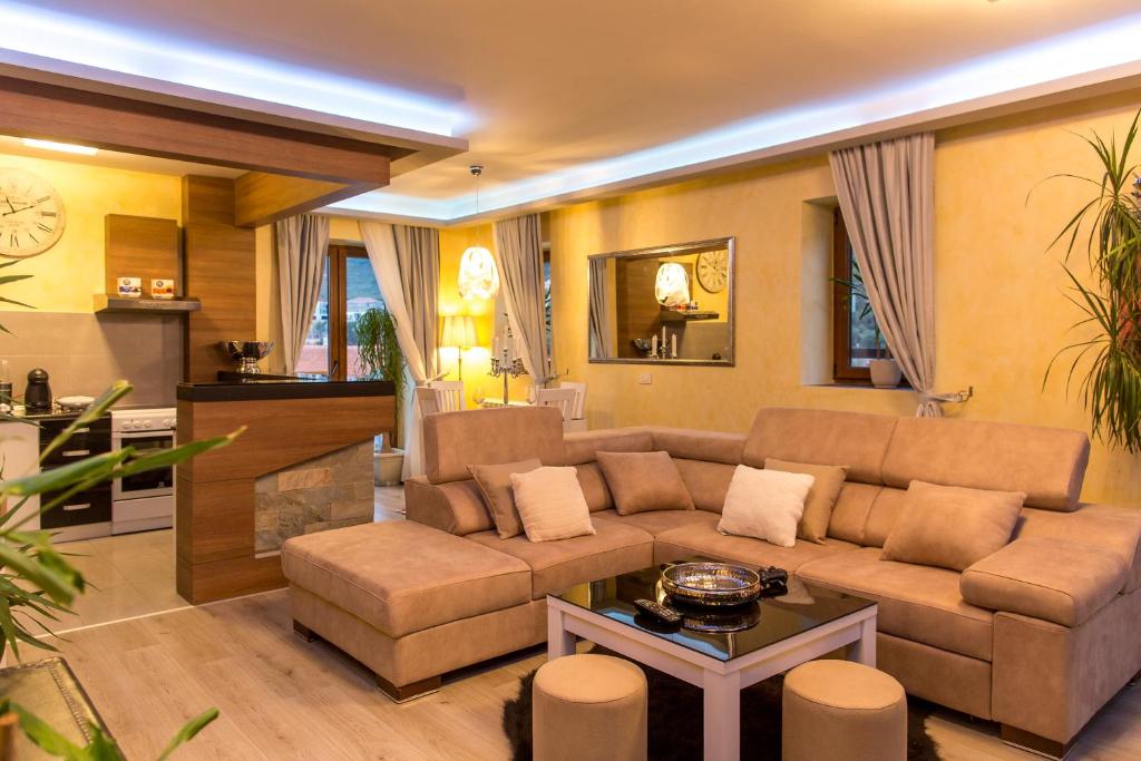 a living room with a couch and a table at Blanche Cliff Apartments in Sveti Stefan