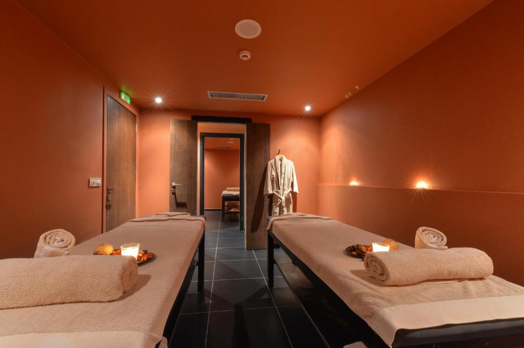 a room with three beds with candles on them at Horizon Blu Boutique Hotel in Kalamata