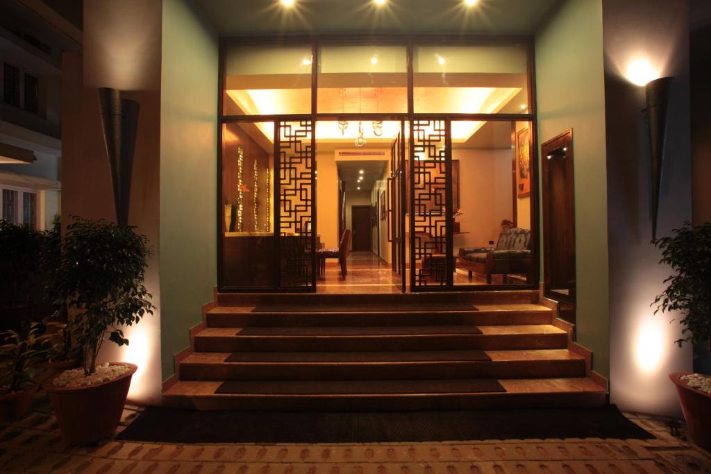 a staircase leading to a house at night at juSTa MG Road in Bangalore