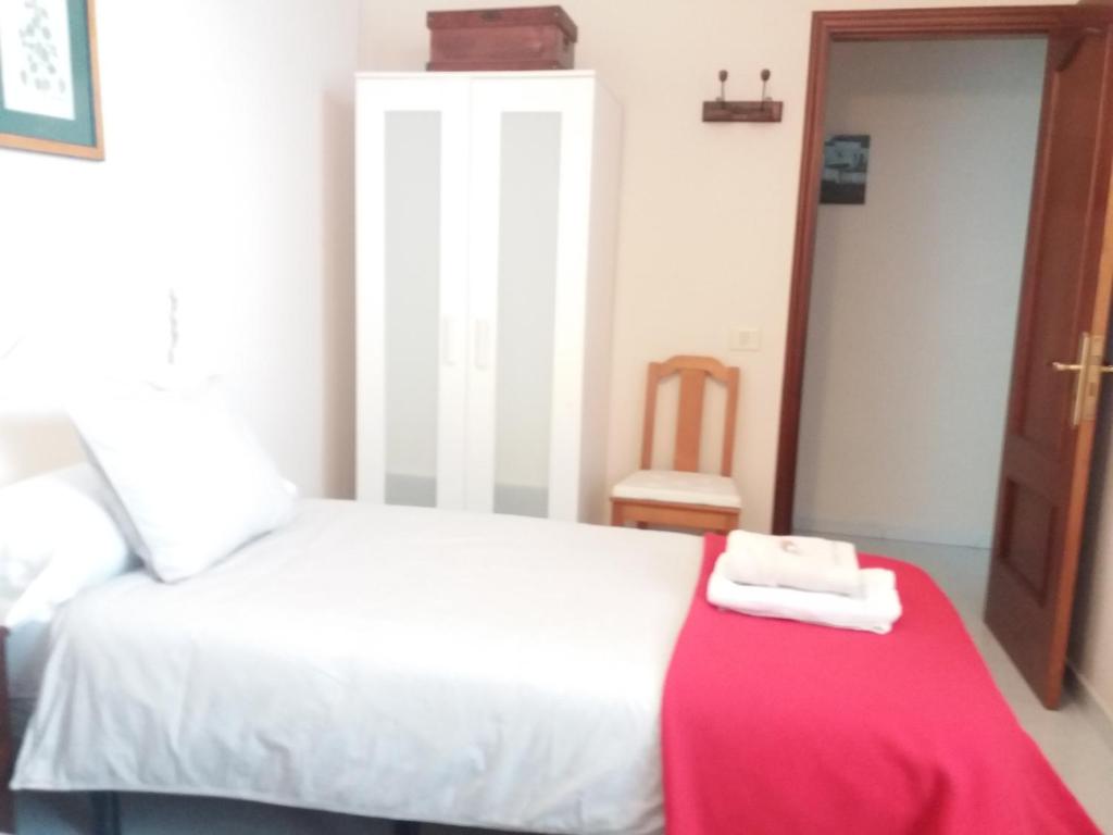 A bed or beds in a room at Apartamento Esperanto