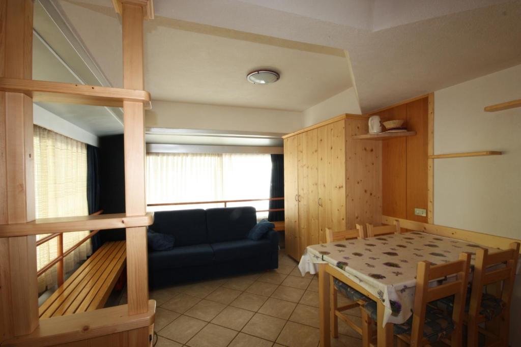 a living room with a bunk bed and a table at Marilleva 1400 Appartamenti Montana in Marilleva