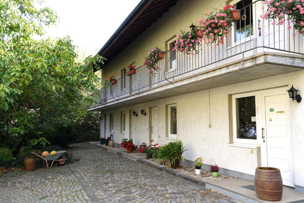 a building with flowers on the balconies and a patio at Landhotel Lützen-Stadt in Lützen