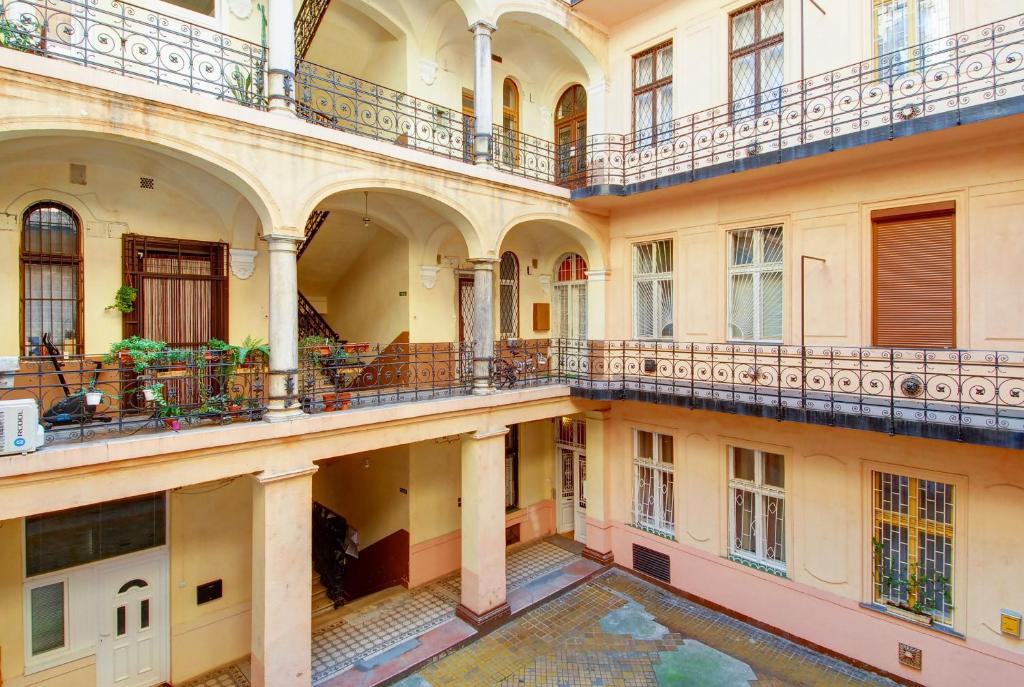 ブダペストにあるマンディ アパートメントのバルコニーと中庭付きの古い建物