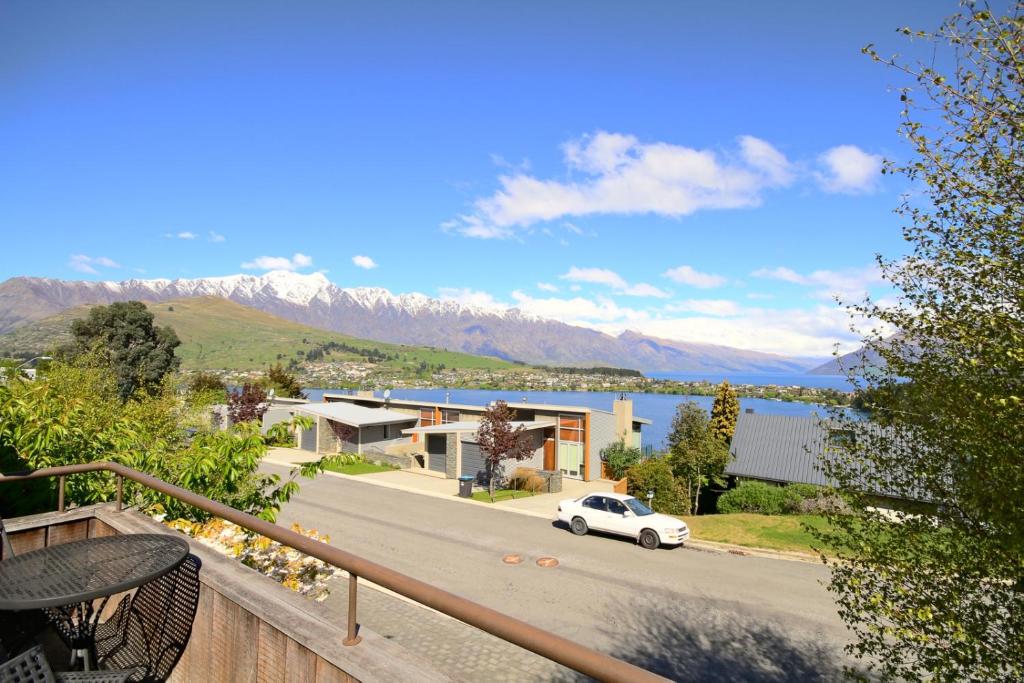 a view from a balcony of a house and a car at Earnslaw Central Views A in Queenstown