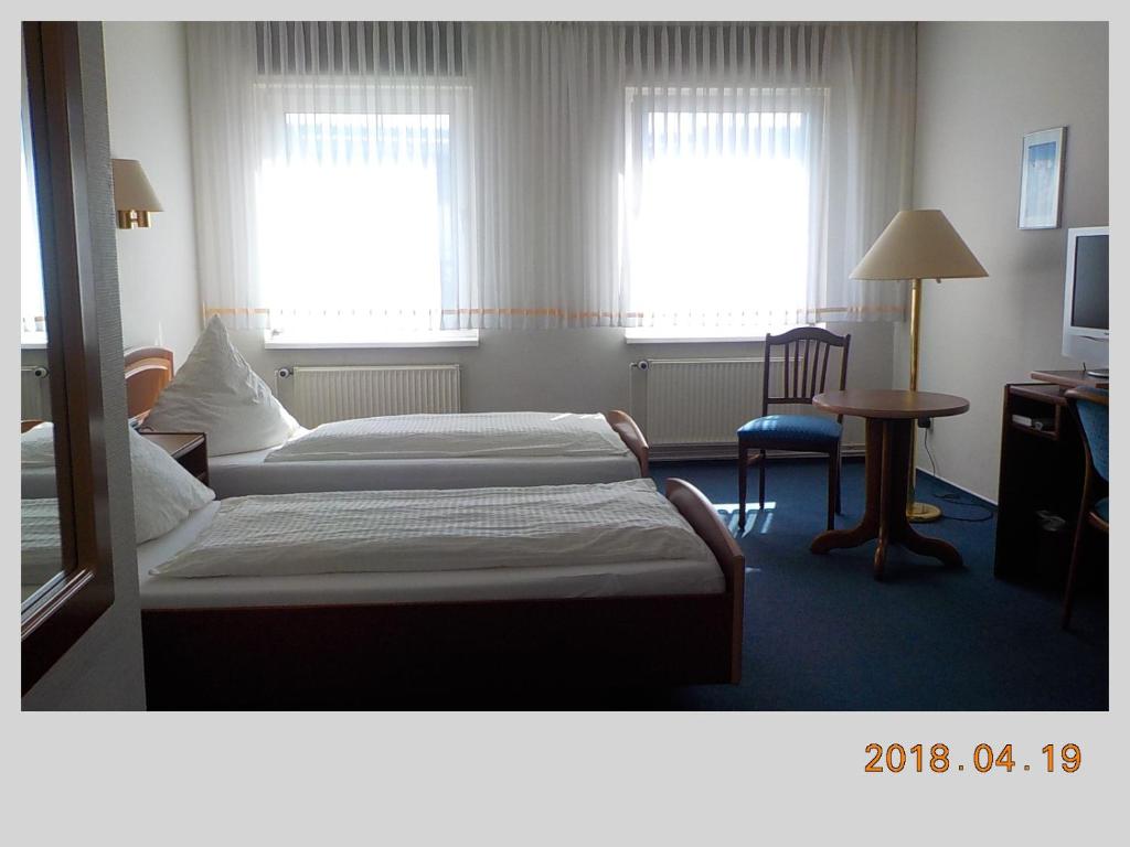 Ein Bett oder Betten in einem Zimmer der Unterkunft Porsche Hotel